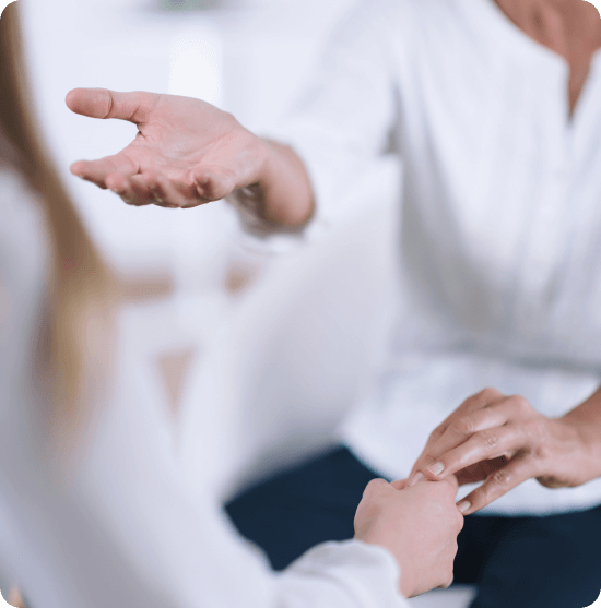 Personas hablando mientras se coge de la mano en una consulta o gabinete.